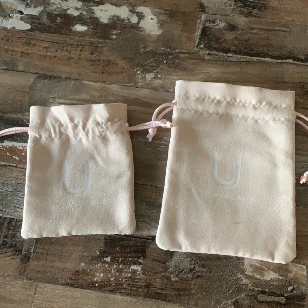 Two small and medium Uncommon James dust bags